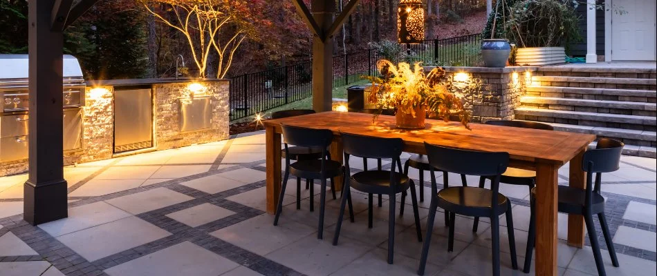 Patio area with table and outdoor kitchen in Will-O-Dean Acres, NC.