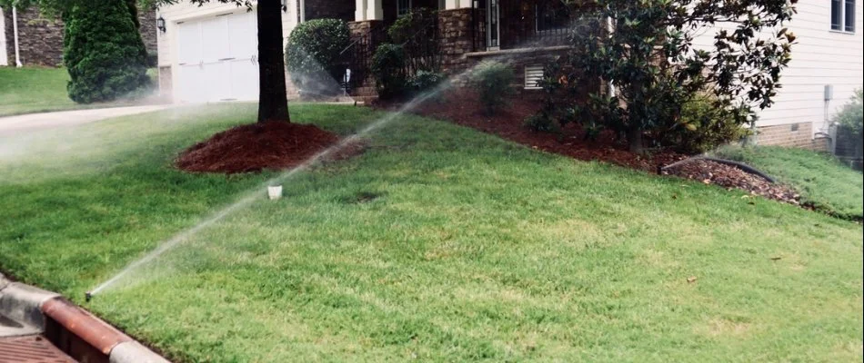 Sprinkler system spraying water on a lawn in Neuse, NC.